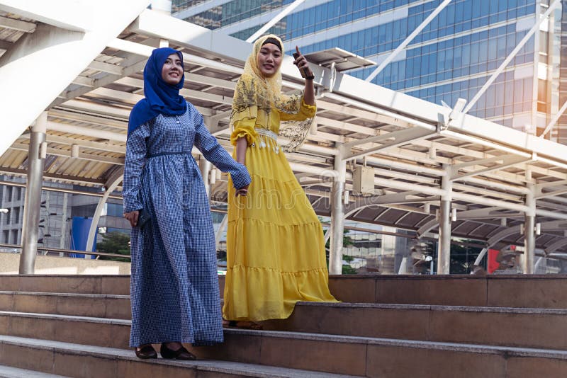 Fashion portrait of two young beautiful muslim woman wearing hijab