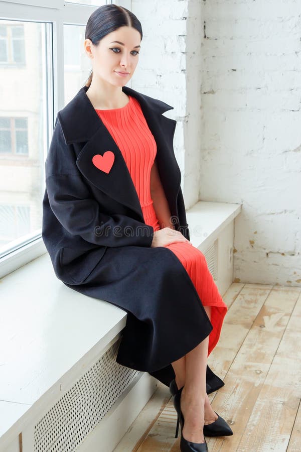 Fashion portrait of young beautiful woman in red dress and coat. stock photos Fashion portrait of young beautiful woman in red dress and coat. stock photos