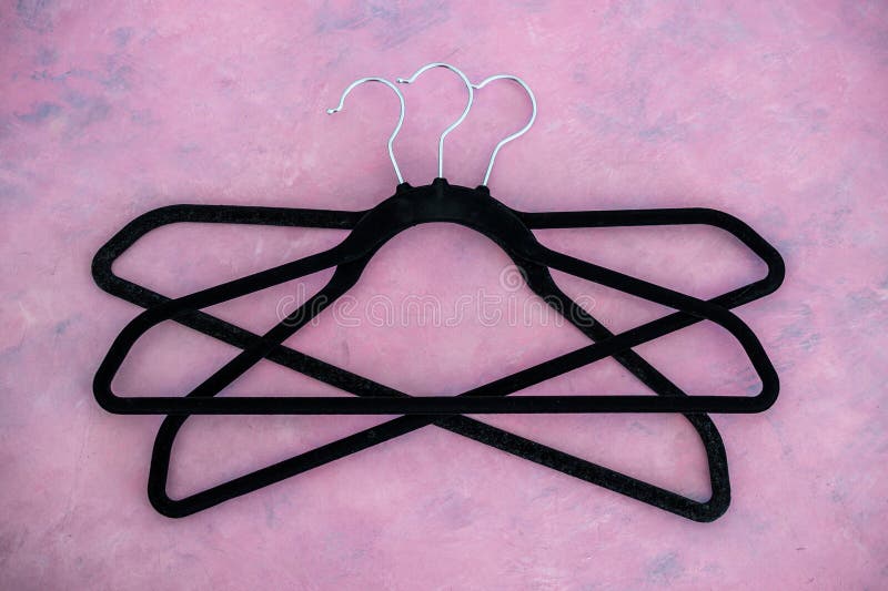 Fashion and shopping, group of clothes hangers creating geometric shape on pink background royalty free stock images Fashion and shopping, group of clothes hangers creating geometric shape on pink background royalty free stock images