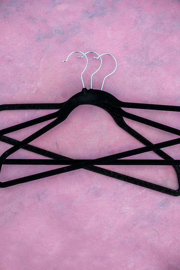 Fashion and shopping, group of clothes hangers creating geometric shape on pink background stock images Fashion and shopping, group of clothes hangers creating geometric shape on pink background stock images