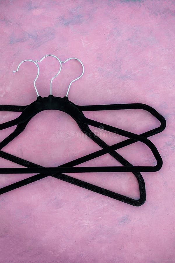Fashion and shopping, group of clothes hangers creating geometric shape on pink background stock photos Fashion and shopping, group of clothes hangers creating geometric shape on pink background stock photos
