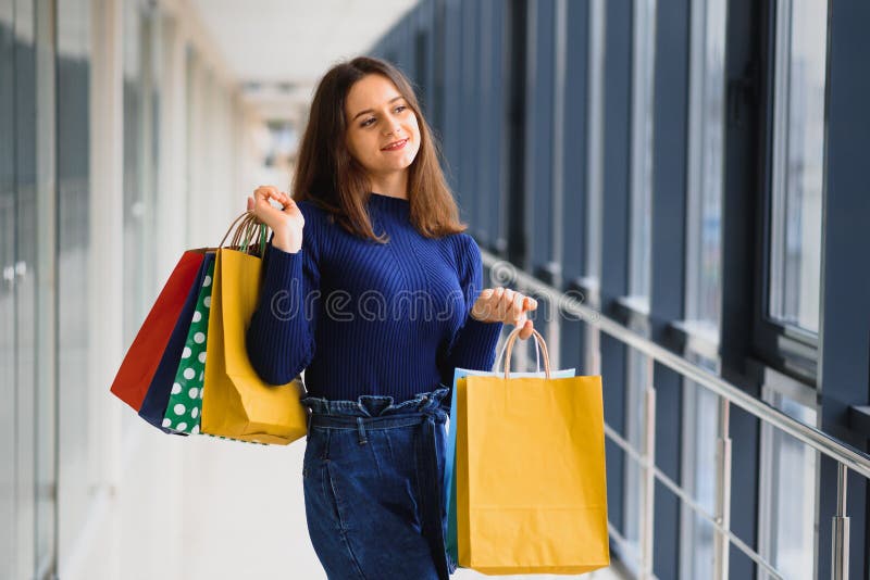 Young Couple Shopping Bags Spending Time Shopping Mall Woman Showing Stock  Photo by ©VitalikRadko 223508024