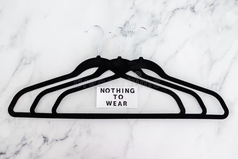 Fashion and shopping, Nothing To Wear text on group of empty clothes hangers creating geometric shape on marble background stock photos Fashion and shopping, Nothing To Wear text on group of empty clothes hangers creating geometric shape on marble background stock photos