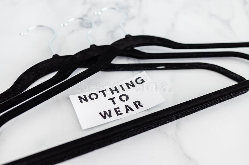 Fashion and shopping, Nothing To Wear text on group of empty clothes hangers creating geometric shape on marble background stock images Fashion and shopping, Nothing To Wear text on group of empty clothes hangers creating geometric shape on marble background stock images