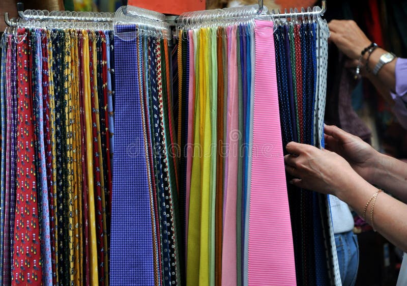 Choosing from many colored ties in an italian market. Choosing from many colored ties in an italian market