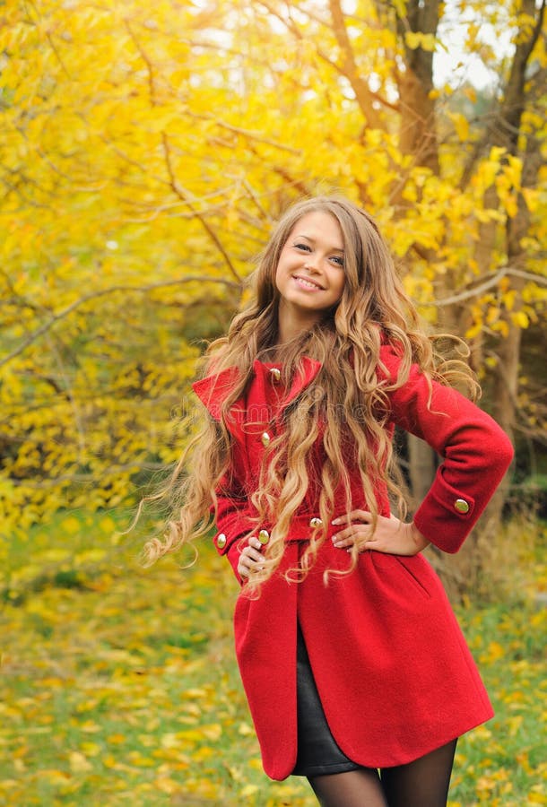 Fashion woman dressed in red coat in autumn park. royalty free stock image Fashion woman dressed in red coat in autumn park. royalty free stock image