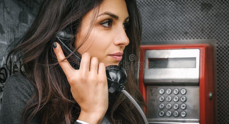Fashion woman talking in the retro phone booth stock images Fashion woman talking in the retro phone booth stock images
