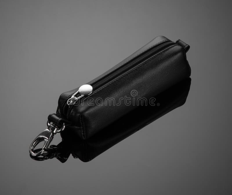 Leather key case with zipper on black background. Leather key case with zipper on black background