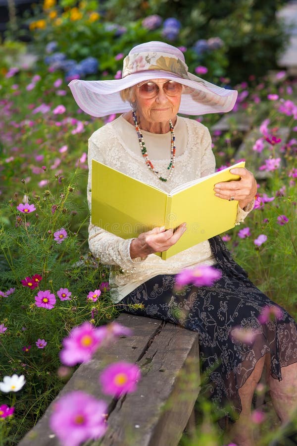 Fashionable Old Lady Reading In Her Garden Stock Photo ...