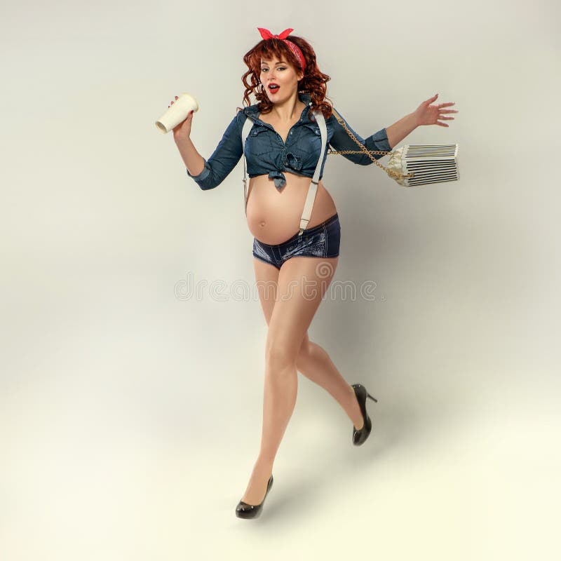 Fashionable redhead pregnant woman in pin up style stock image Fashionable redhead pregnant woman in pin up style stock image