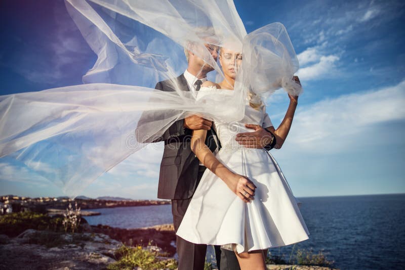 Fashionable wedding couple near ocean. Bride and Groom. Outdoor portrait stock photography Fashionable wedding couple near ocean. Bride and Groom. Outdoor portrait stock photography
