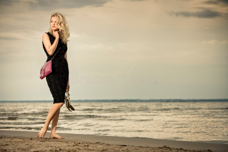 Fashionable woman on beach.