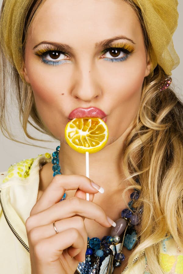 Fashionable young woman holding a candy