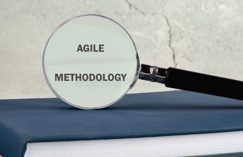 Fast changes concept. AGILE METHODOLOGY on the glass of a magnifying glass on a gray background stock photos