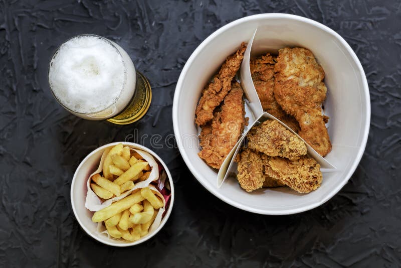 Fast food, Beer, fried chicken legs, wings, nuggets, french frie royalty free stock photography Fast food, Beer, fried chicken legs, wings, nuggets, french frie royalty free stock photography