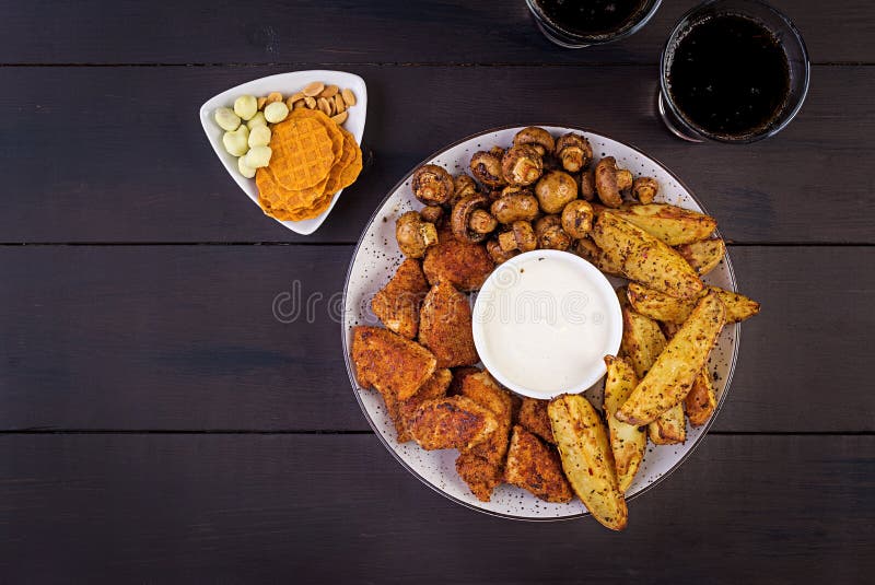 Fast food chicken nuggets with ketchup, french fries, baked mushrooms and cola. stock image Fast food chicken nuggets with ketchup, french fries, baked mushrooms and cola. stock image