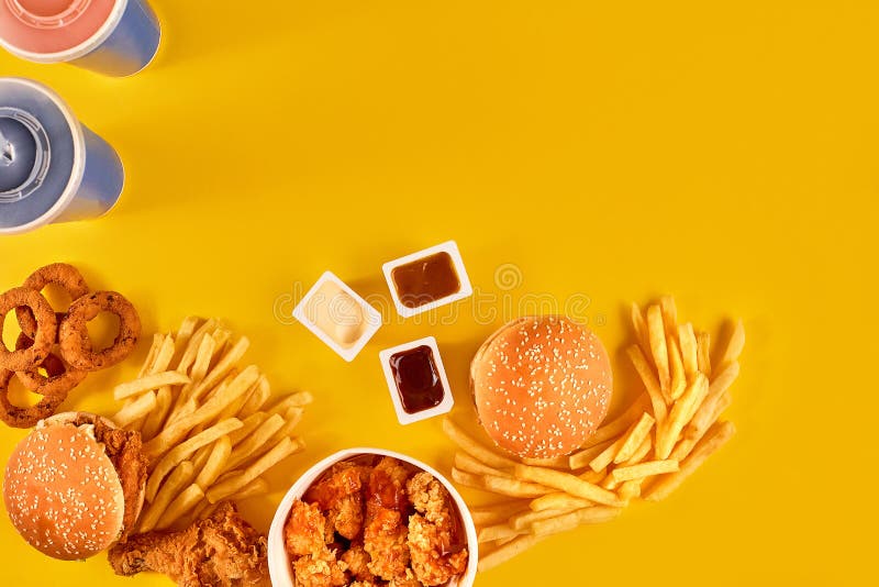 Fast food dish top view. Meat burger, potato chips and wedges. Take away composition. French fries, hamburger. Cheeseburger, mayonnaise.