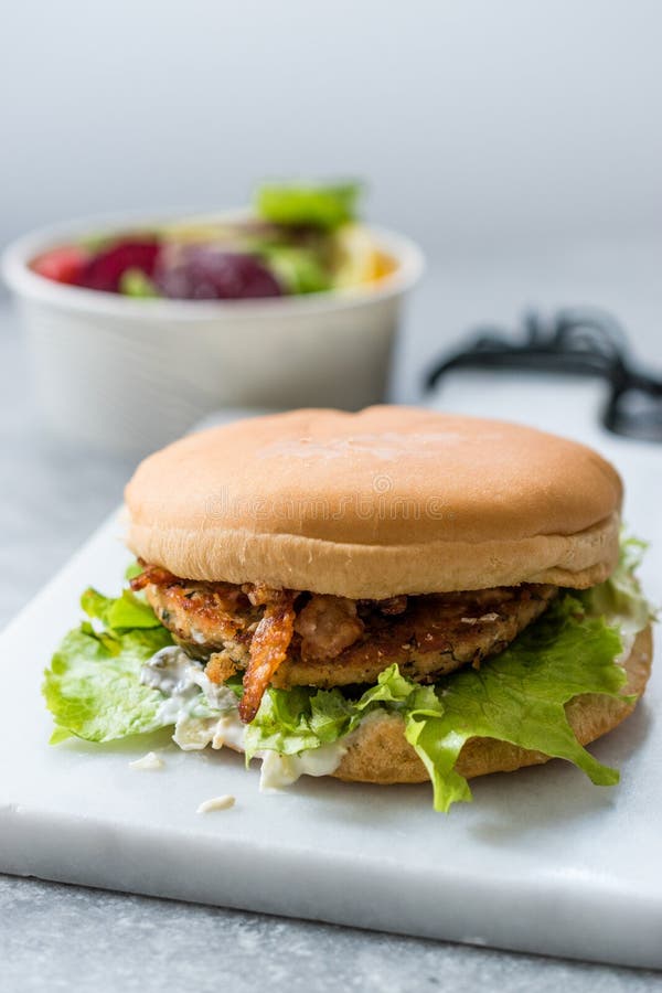 Fast Food Menu Salmon Burger with Take Away Salad in Plastic Box.