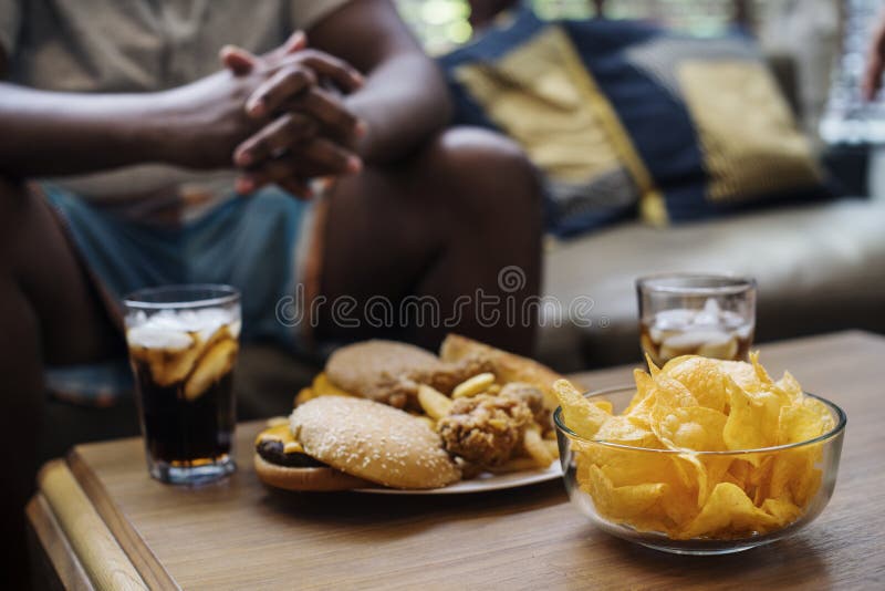 Fast food on a sofa table stock photo. Image of dinner 116369270