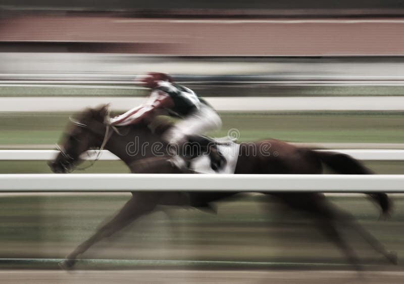 Panning image of a jockey riding a horse with motion blur. Panning image of a jockey riding a horse with motion blur