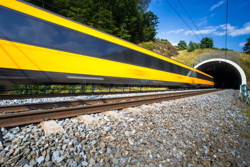 Fast train passing through a tunnel on a lovely summer day