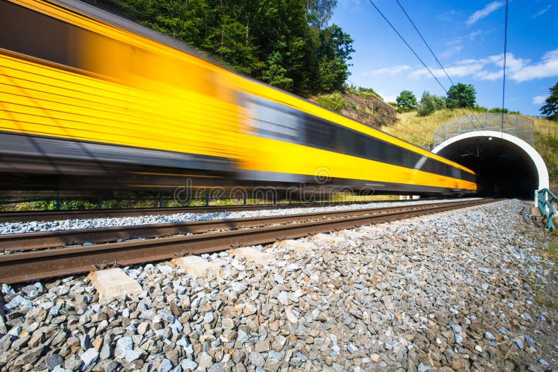 Fast train passing through a tunnel on a lovely summer day