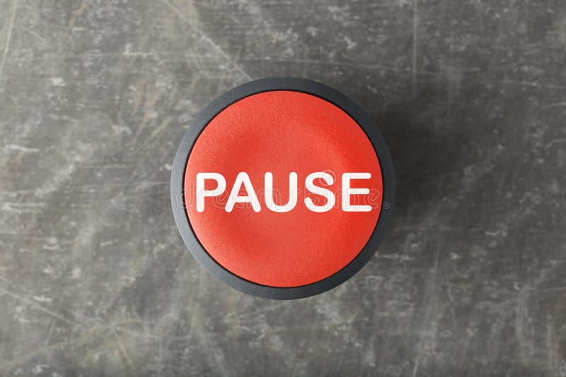 Overhead of a red pause push button on concrete background. Overhead of a red pause push button on concrete background