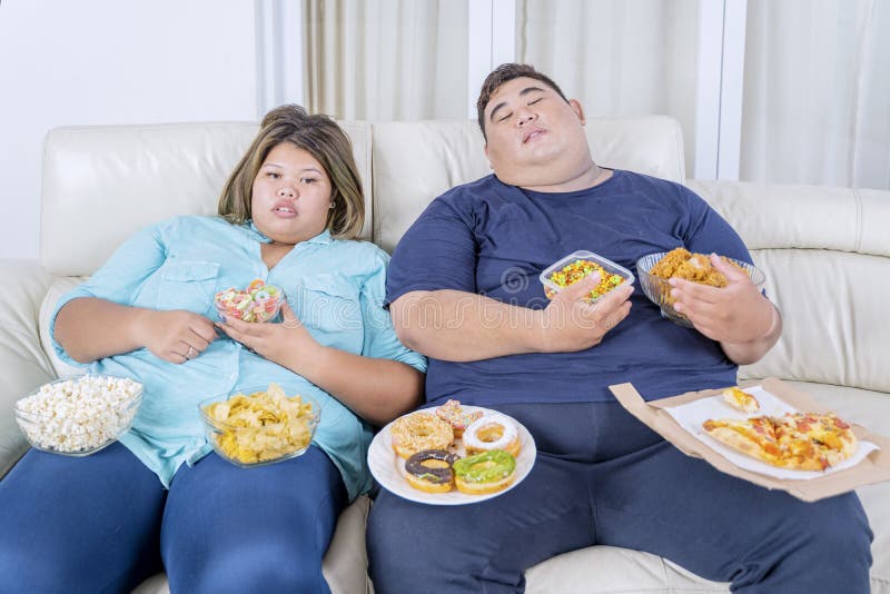 fat-couple-sleeping-eating-watching-tv-portrait-asian-television-boredom-junk-foods-scattered-around-them-169094142.jpg