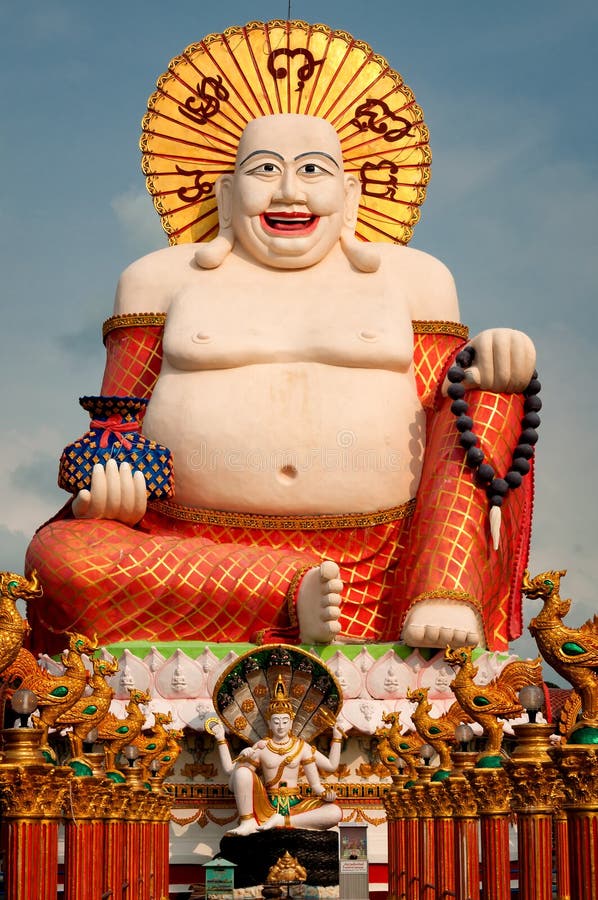 Fat laughing Buddha over blue sky