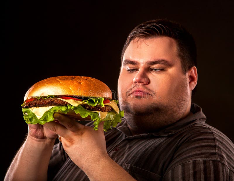 Fat man eating fast food hamberger. 