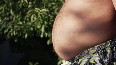 Fat man slaps his belly stock video. Video of liposuction - 260367007