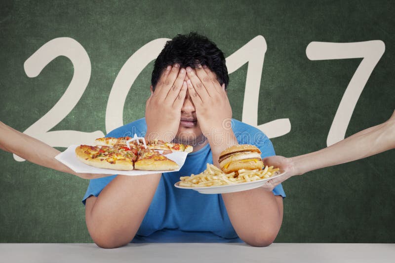 Fat person with junk food and 2017 stock image Fat person with junk food and 2017 stock image