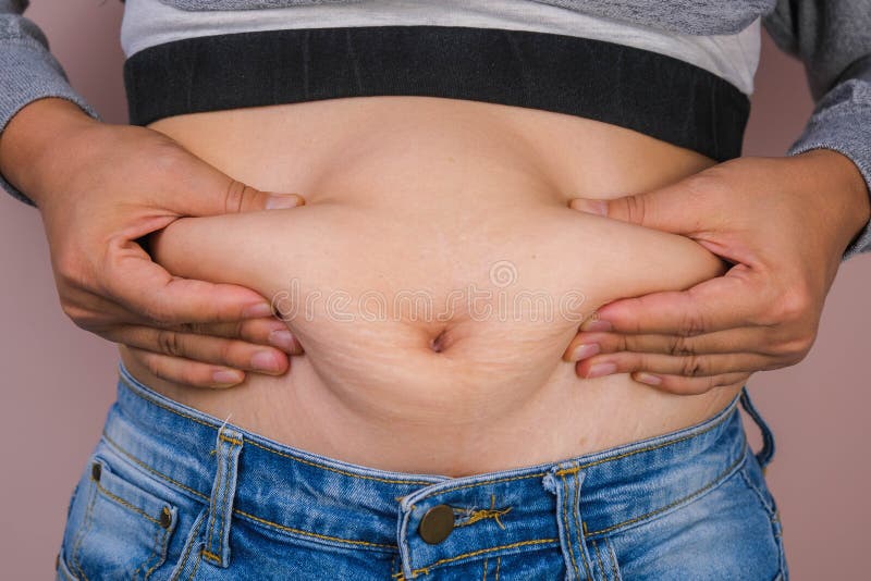 Woman measuring waist with measuring tape,Excess belly fat and