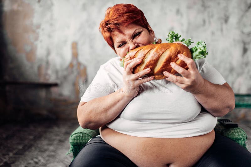 Fat woman sits in chair and eats sandwich, bulimic