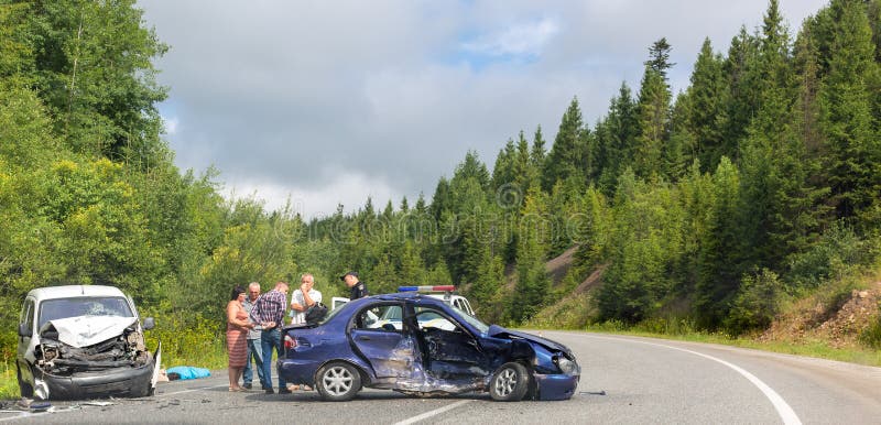 Svalyava, Ukraine. August 11, 2019: Fatal traffic accident. Real event. Two cars crashed on the road. Police officer interrogates participants and witnesses of road accident. Svalyava, Ukraine. August 11, 2019: Fatal traffic accident. Real event. Two cars crashed on the road. Police officer interrogates participants and witnesses of road accident
