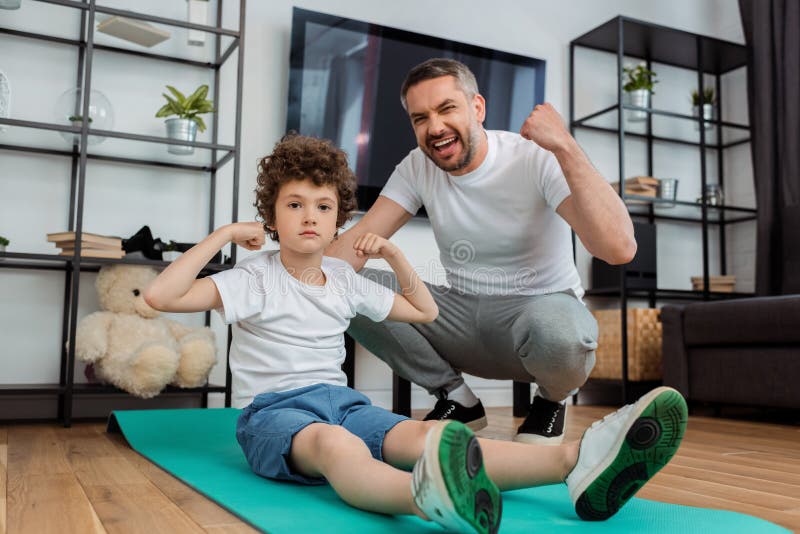 Father Cheering Near Curly Son Showing Stock Photo - Image of ...