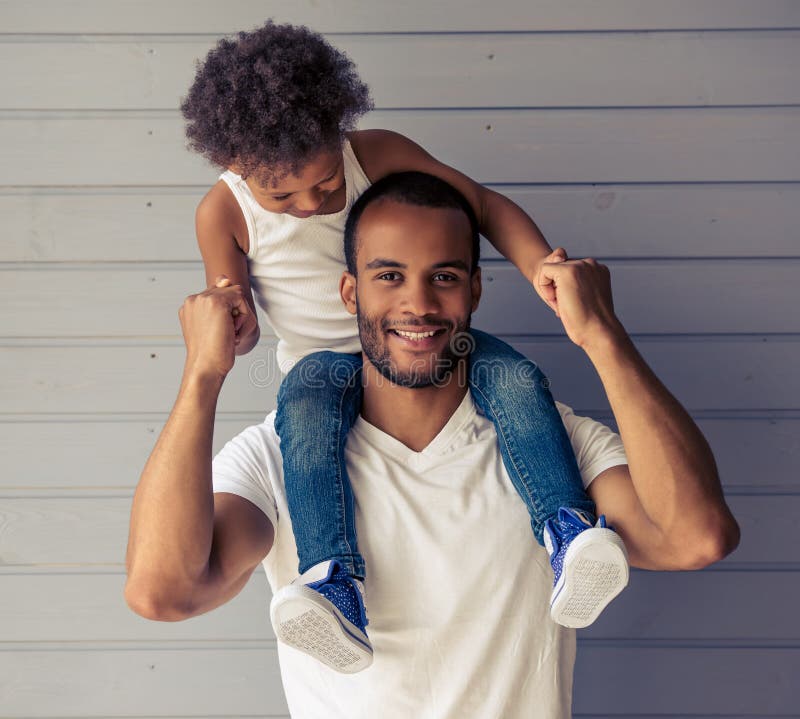 Cheerful african american father giving son piggyback ride outdoors  smiling, Happiness family concepts 6774671 Stock Photo at Vecteezy