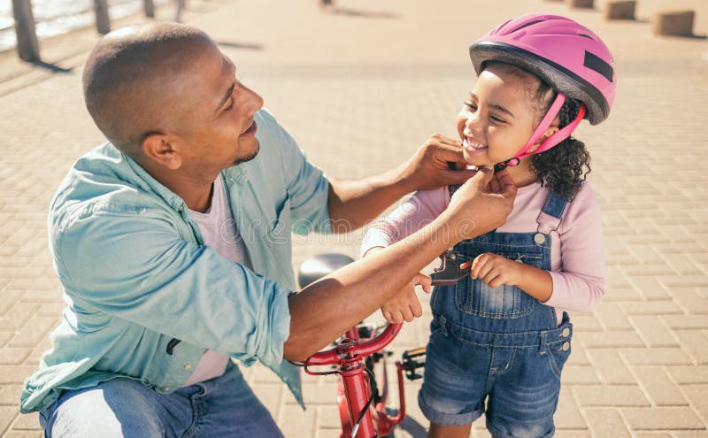 Father, child and safety helmet while outdoor with bicycle on the promenade for fun and quality time while learning to stock images