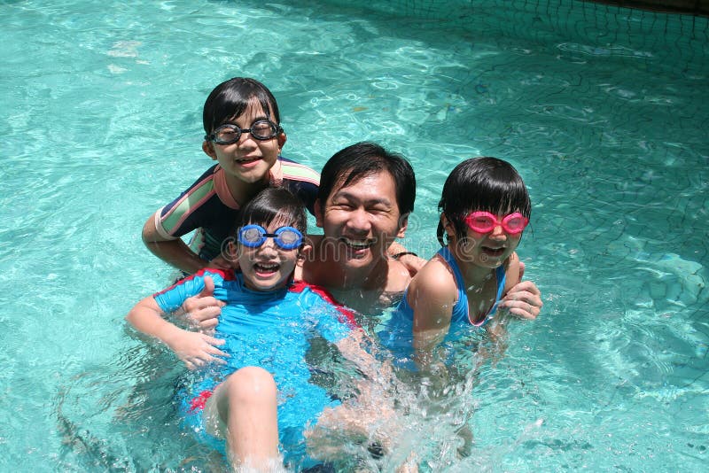 Father and children in the pool