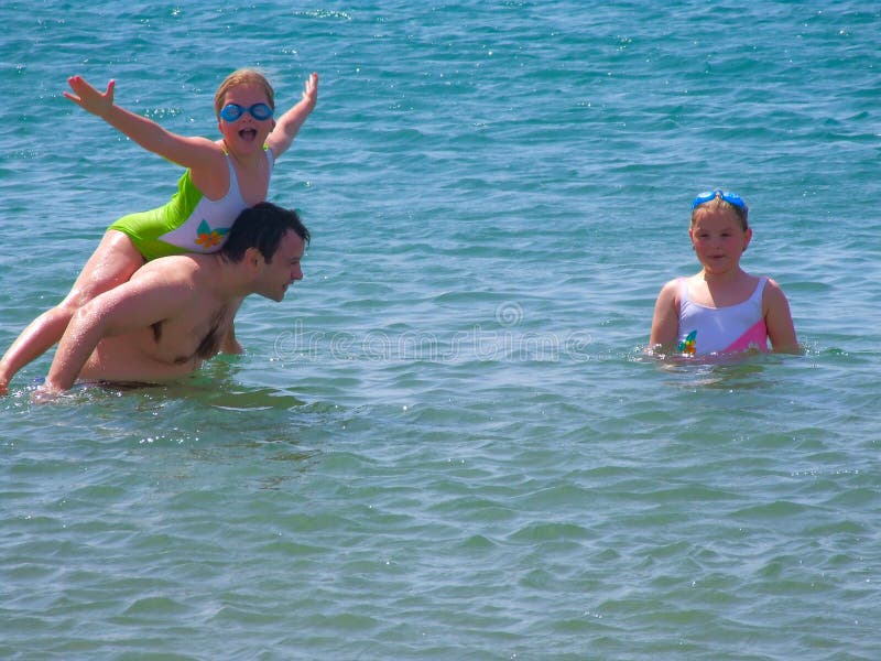 Father with children in sea