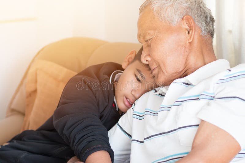 Father and Dad Day concept : Asian retired Grandfather and nephew or grandson, young boy hugging Living in house happily together stock image Father and Dad Day concept : Asian retired Grandfather and nephew or grandson, young boy hugging Living in house happily together stock image