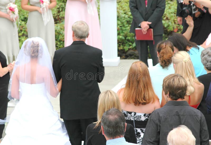 Father escorting his daughter to the altar. Father escorting his daughter to the altar.