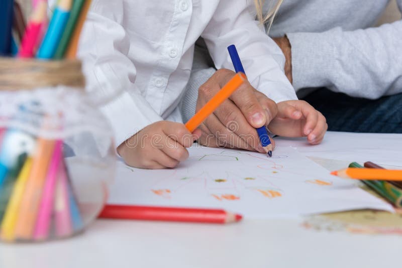 Father and daughter drawing together. Creativity and learning concept Father and daughter drawing together. Creativity and learning concept