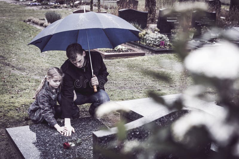 Father and daughter at grave