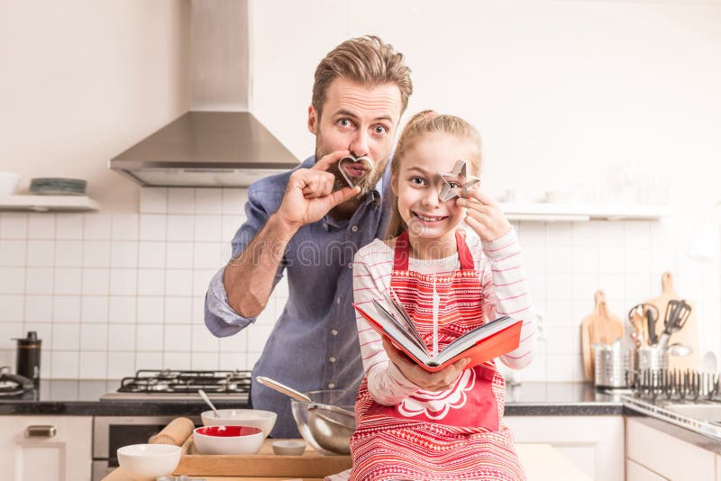 Father and daughter having fun in the kitchen - baking