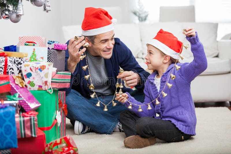 Father And Daughter Holding Christmas Ornaments stock images Father And Daughter Holding Christmas Ornaments stock images