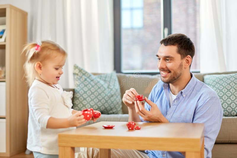 Father and daughter playing tea party at home royalty free stock photo Father and daughter playing tea party at home royalty free stock photo