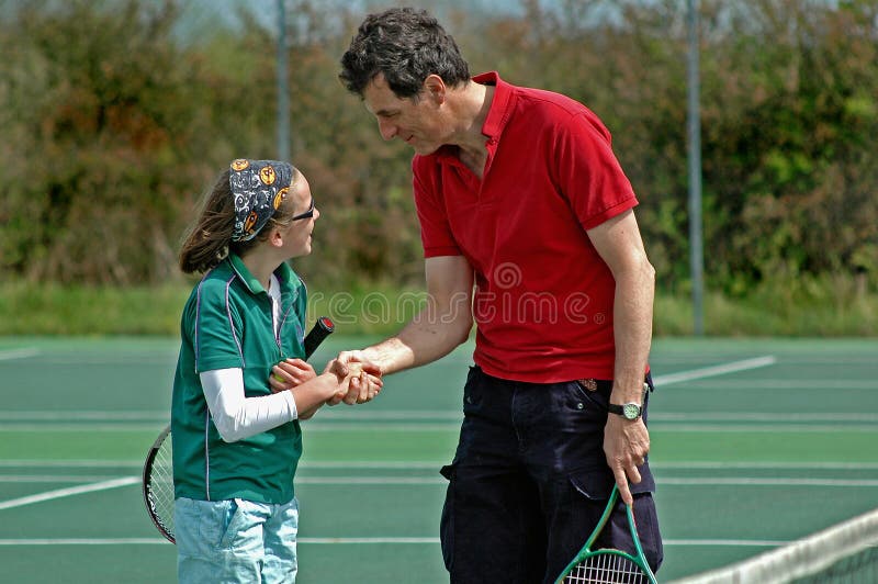 Father and daughter playing tennis