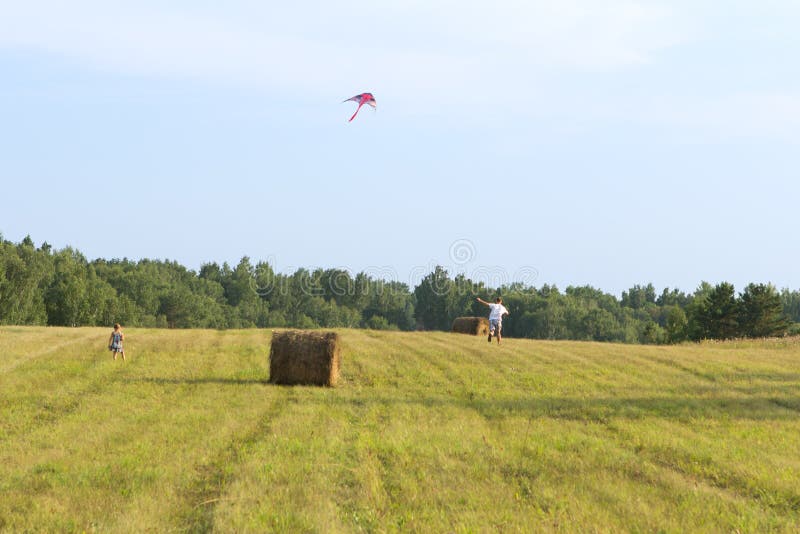 The father and the daughter run across the field. stock image The father and the daughter run across the field. stock image