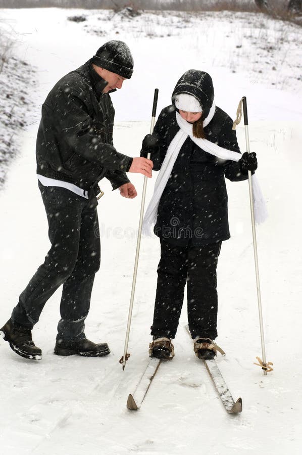 The father, the daughter and skis.